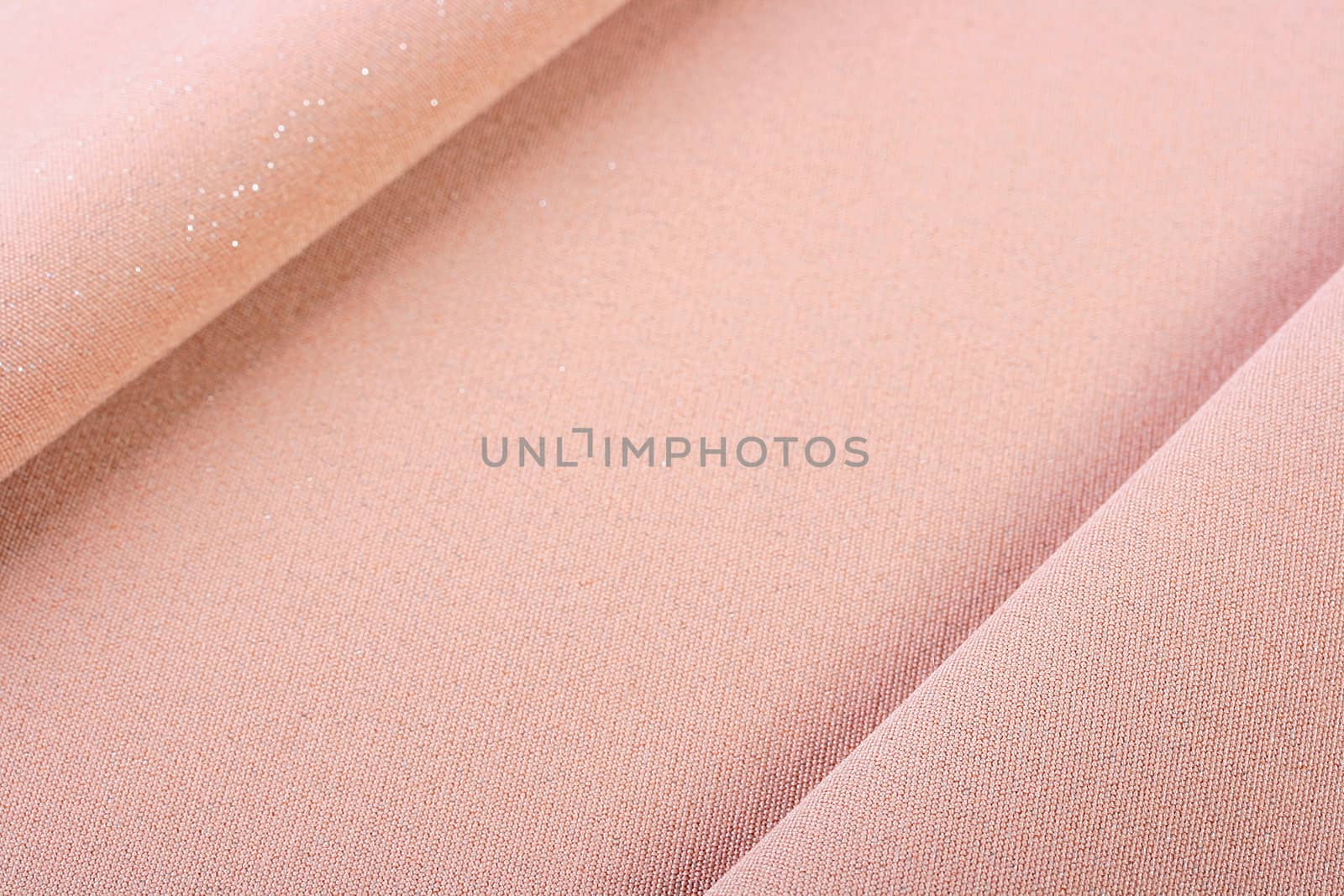 Background from a beige fabric which is used in a clothing industry.