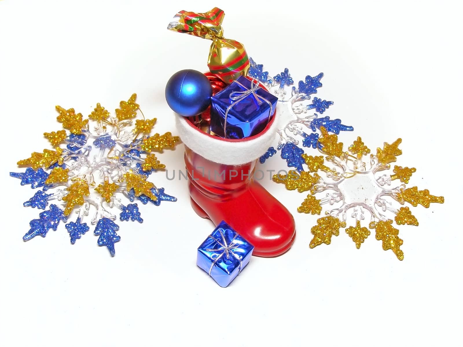 A lot of multicolored decorations and sweets in Christmas boot