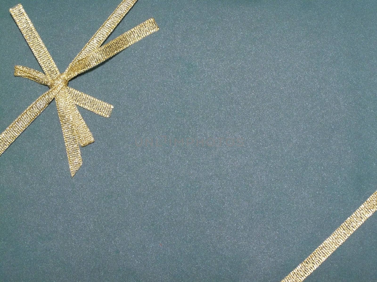 top of gift with golden tie in a bow 