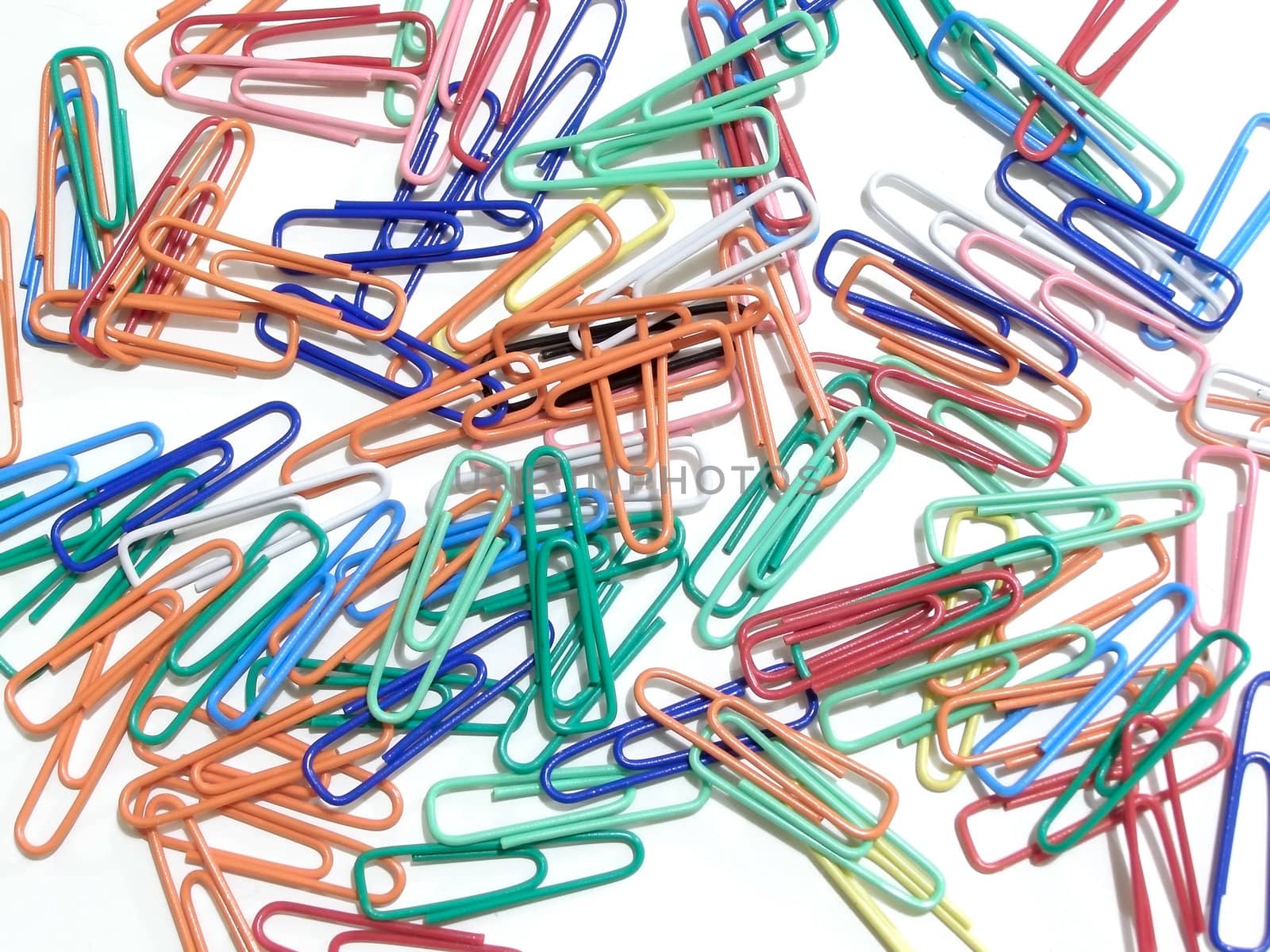 multicolored paper clips spilled on the table       