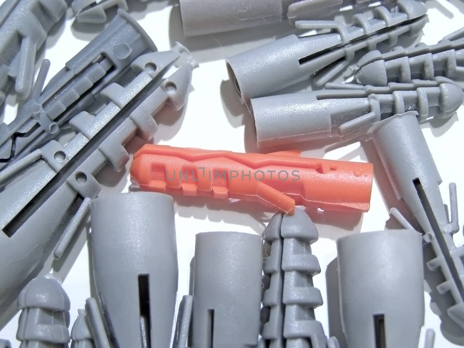 heap of grey dowels and red one       