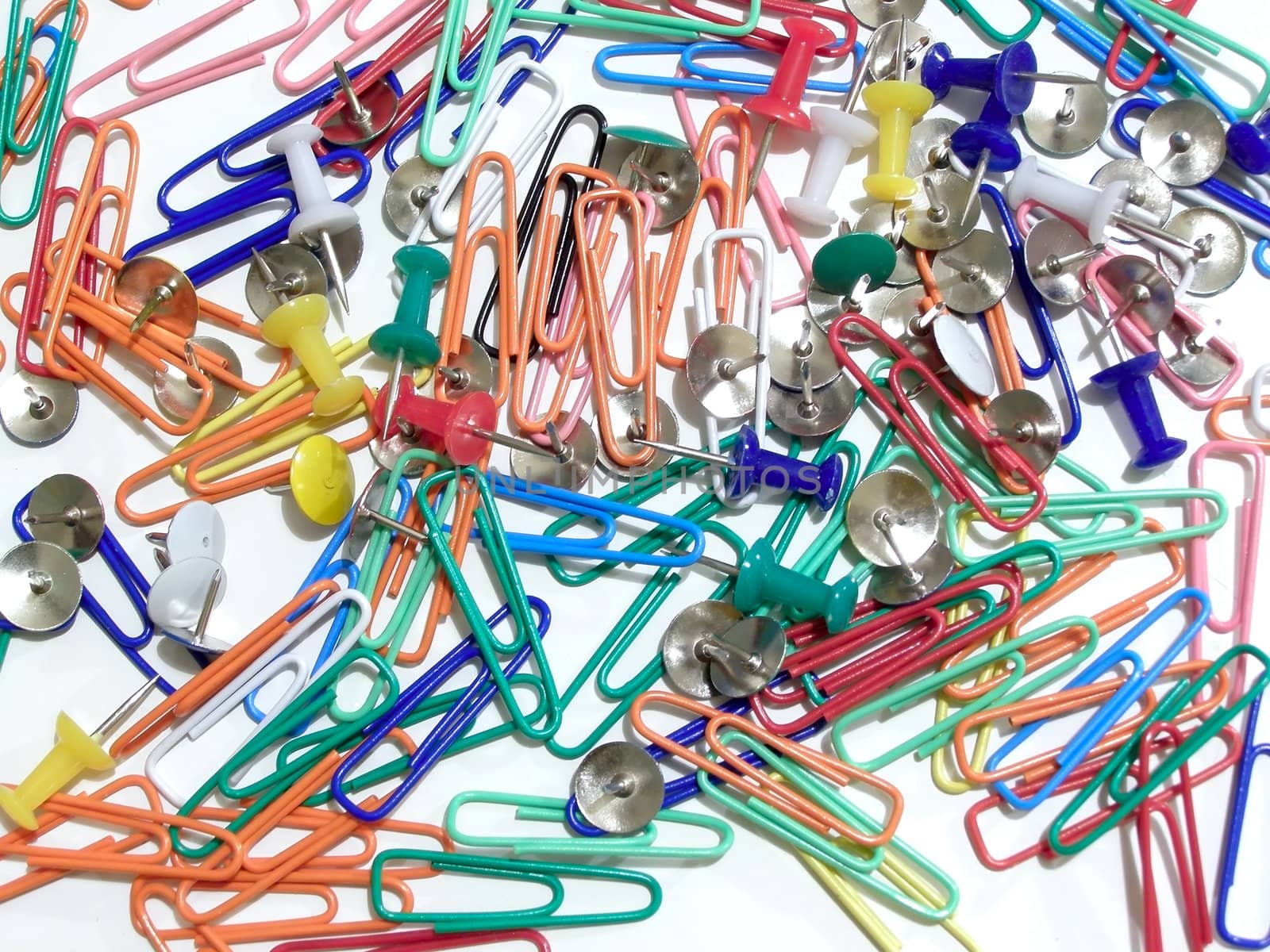 multicolored thumb tacks and paper clips  