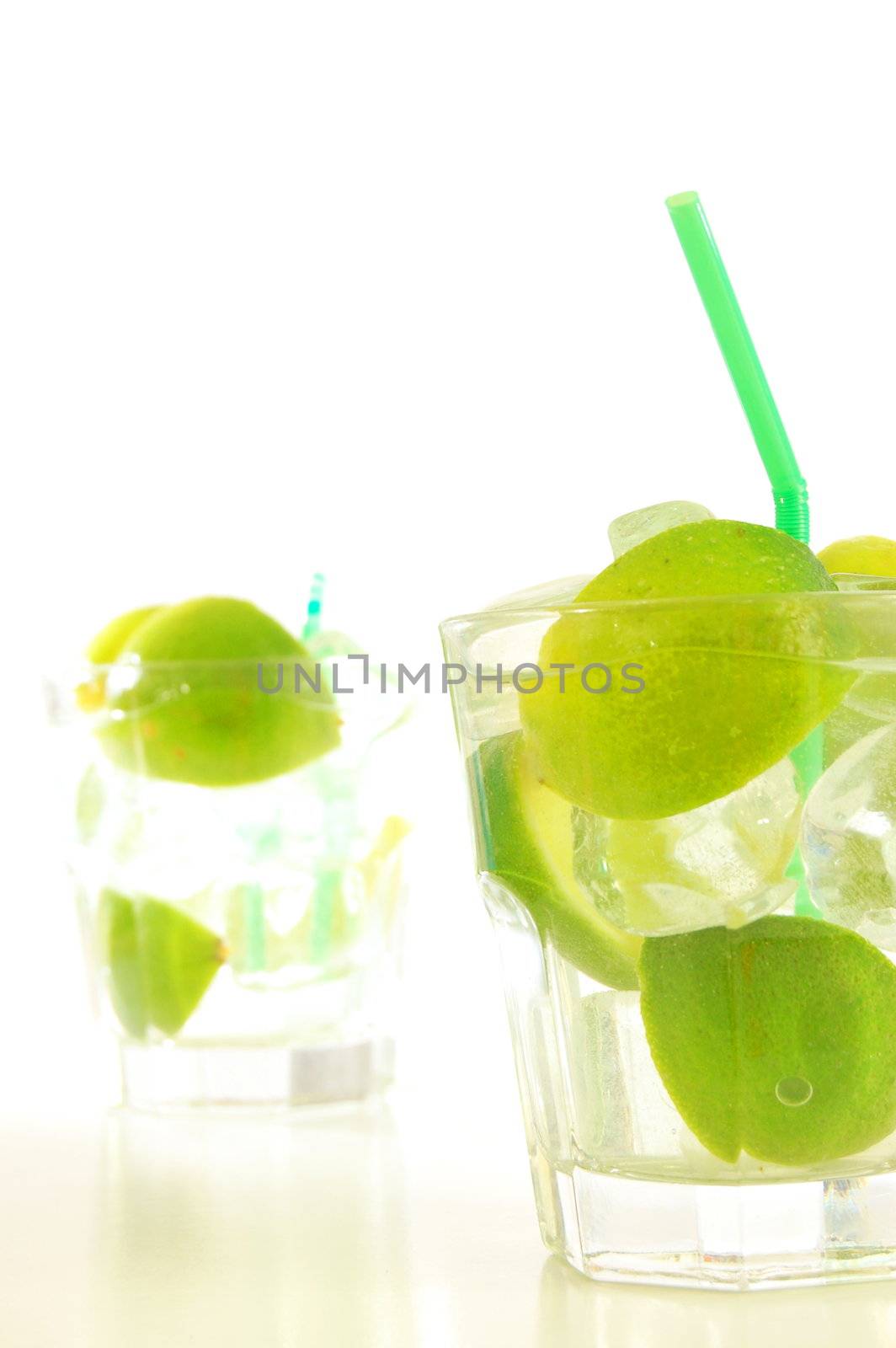 Caipirinha cocktail with lime on white background