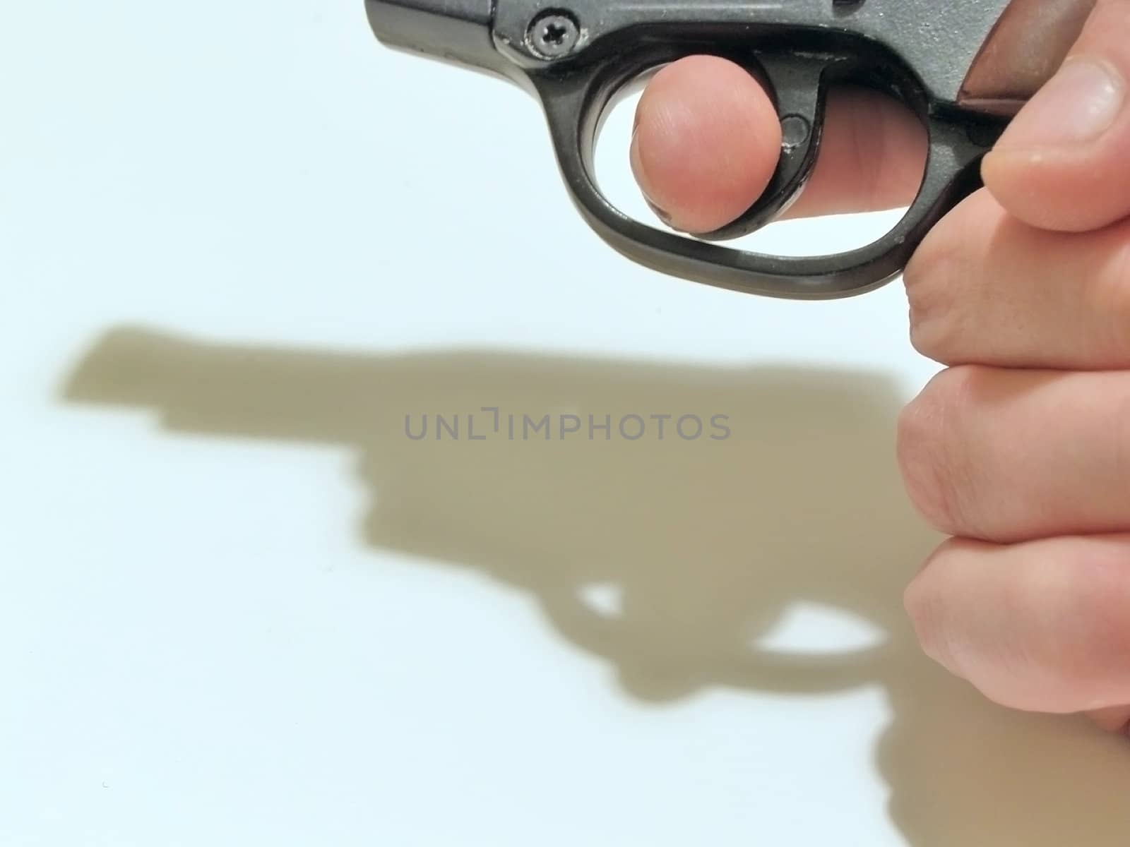 Man hand with gun and it`s shadow    