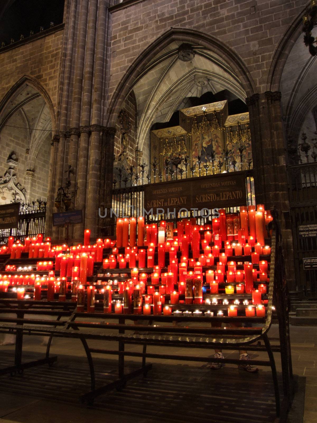 Multitude of glowing candles in beautiful gothic cathedral in Barcelona (Spain).