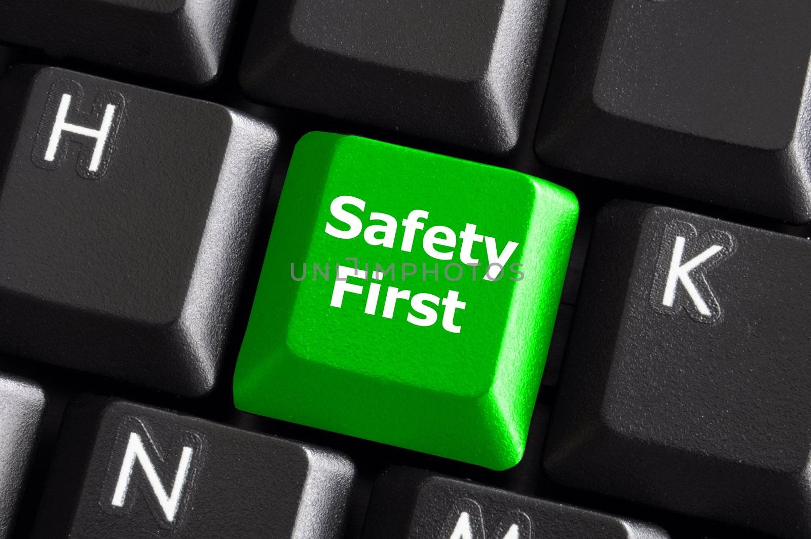 safety first concept with green key on computer keyboard