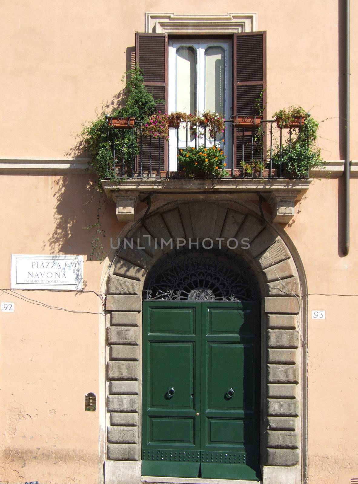 Typical Rome - urban building detail. Balcony and a door.