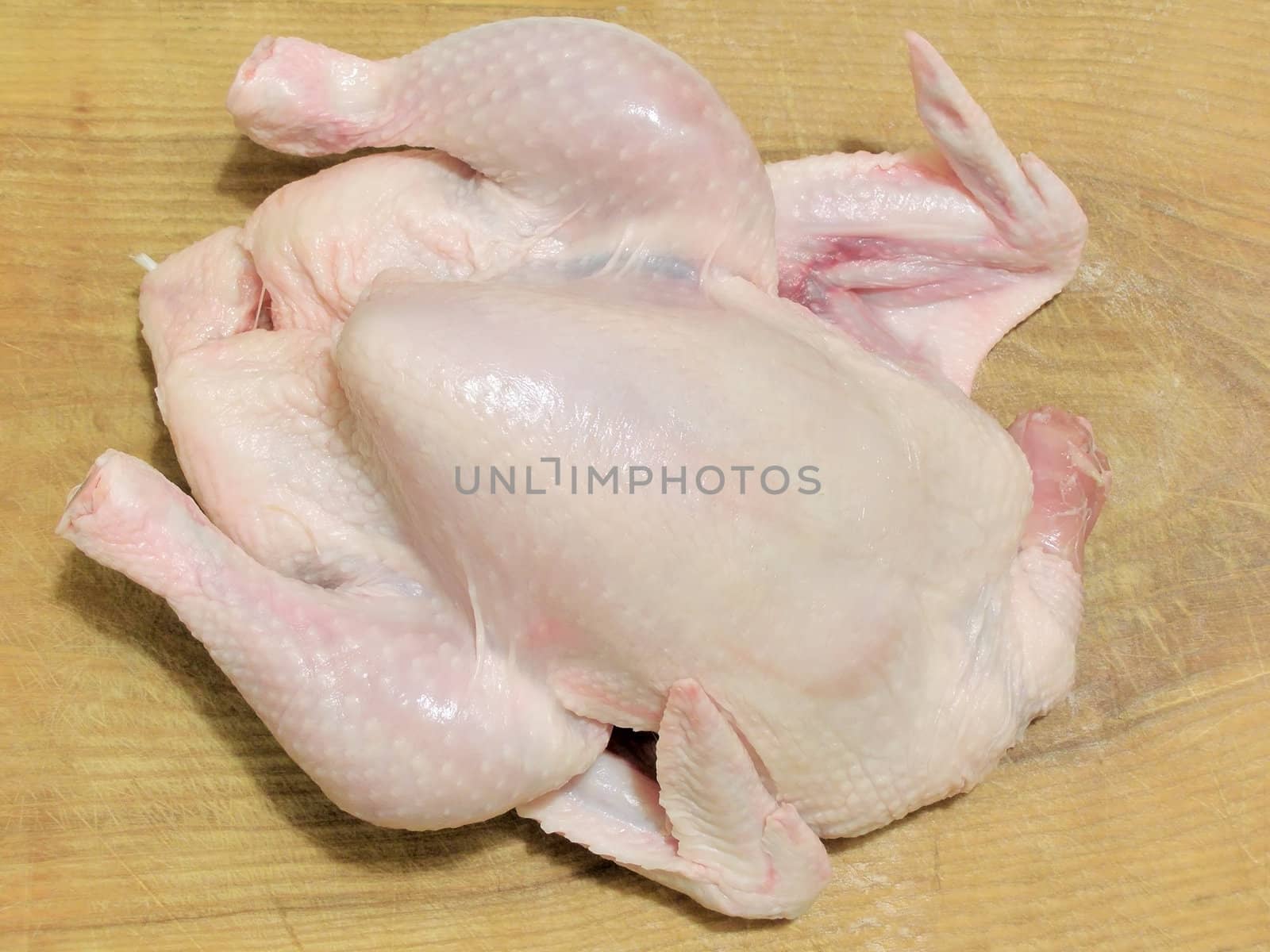 Raw chicken meat on the wood board    