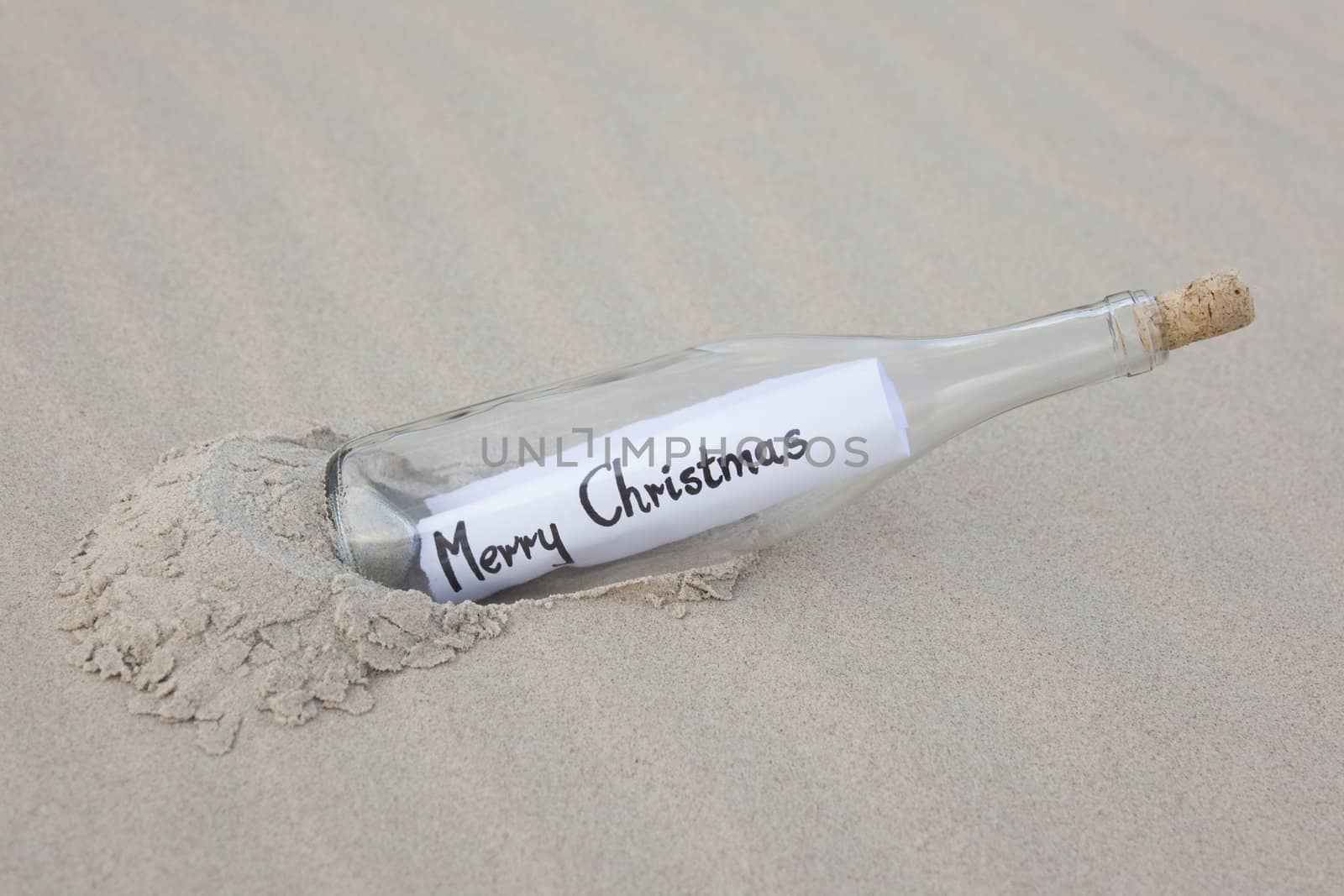 A clear glass bottle washed up on the beach