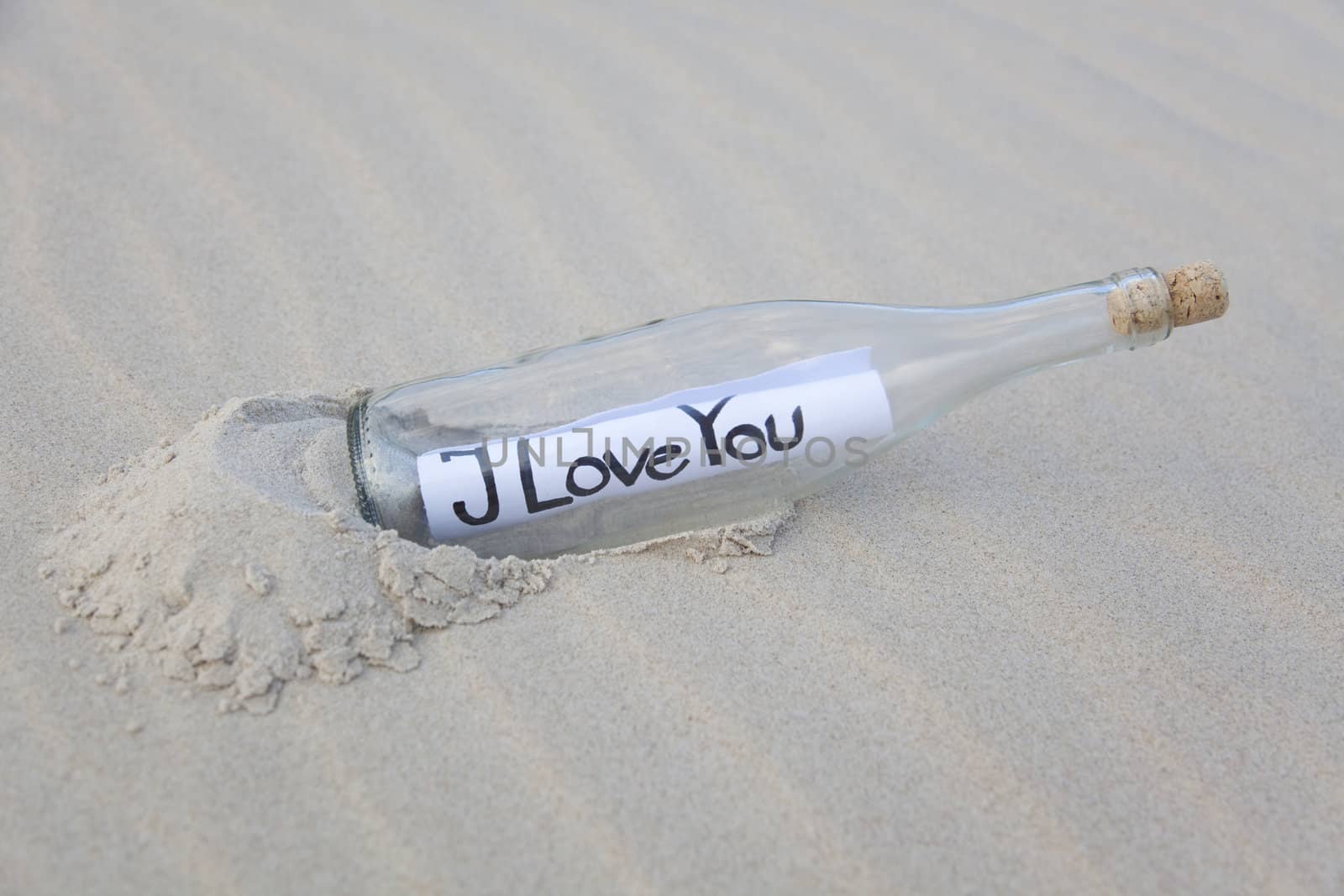 A clear glass bottle washed up on the beach