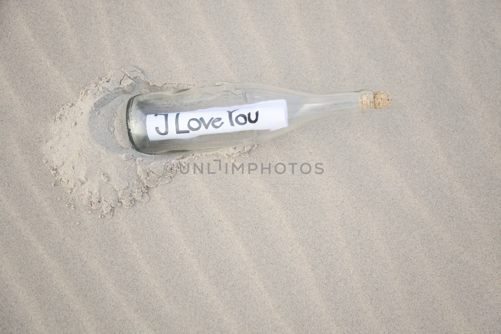 A clear glass bottle washed up on the beach