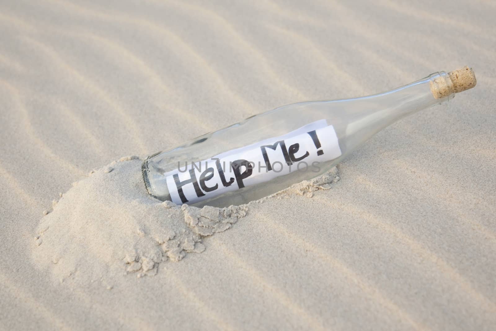 A clear glass bottle washed up on the beach