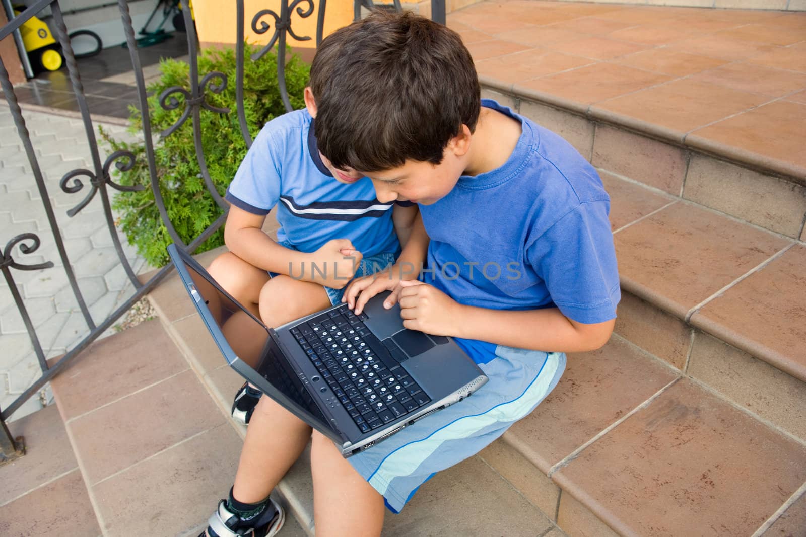 Two cute boy study on computer 
