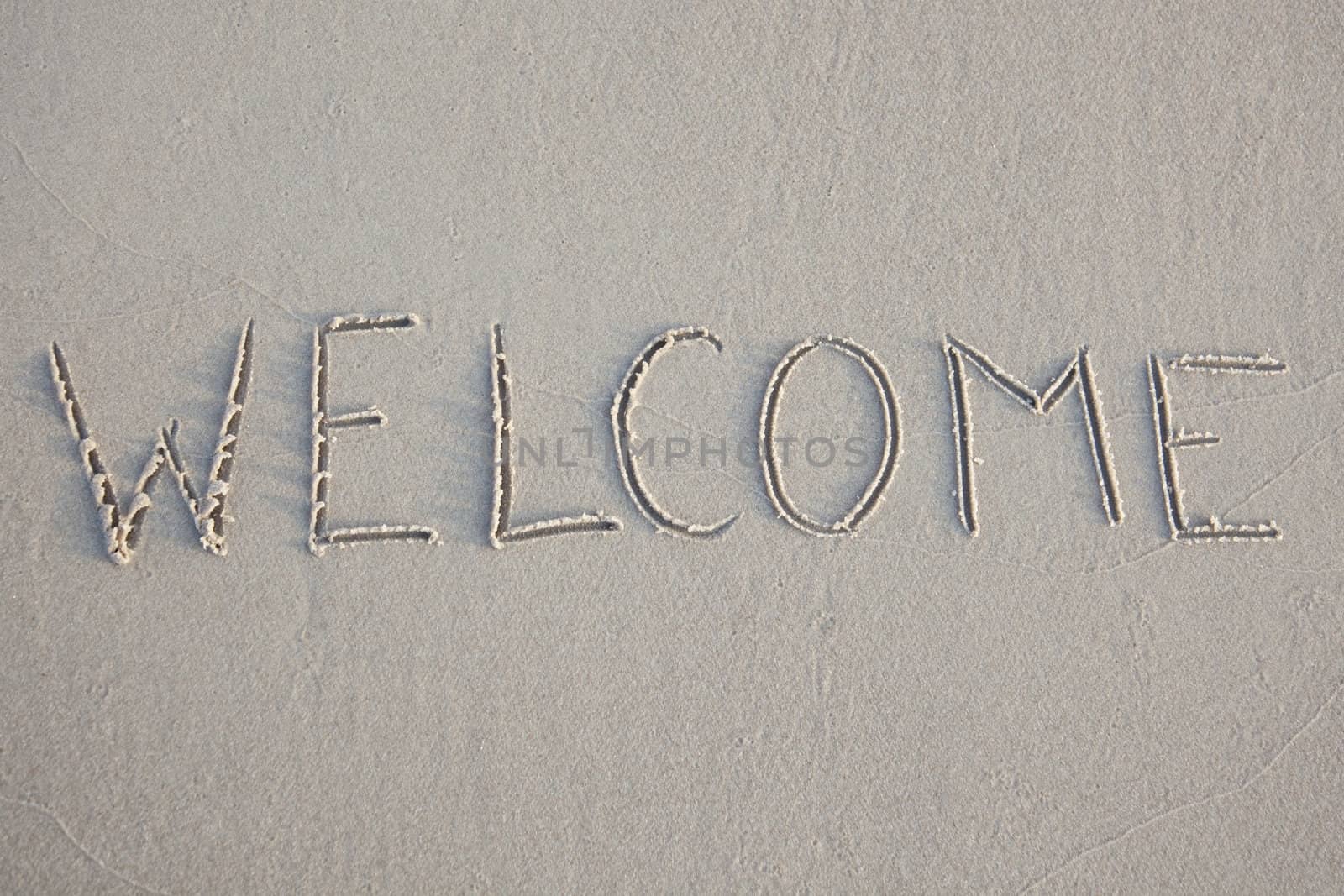 Welcome written in the beach