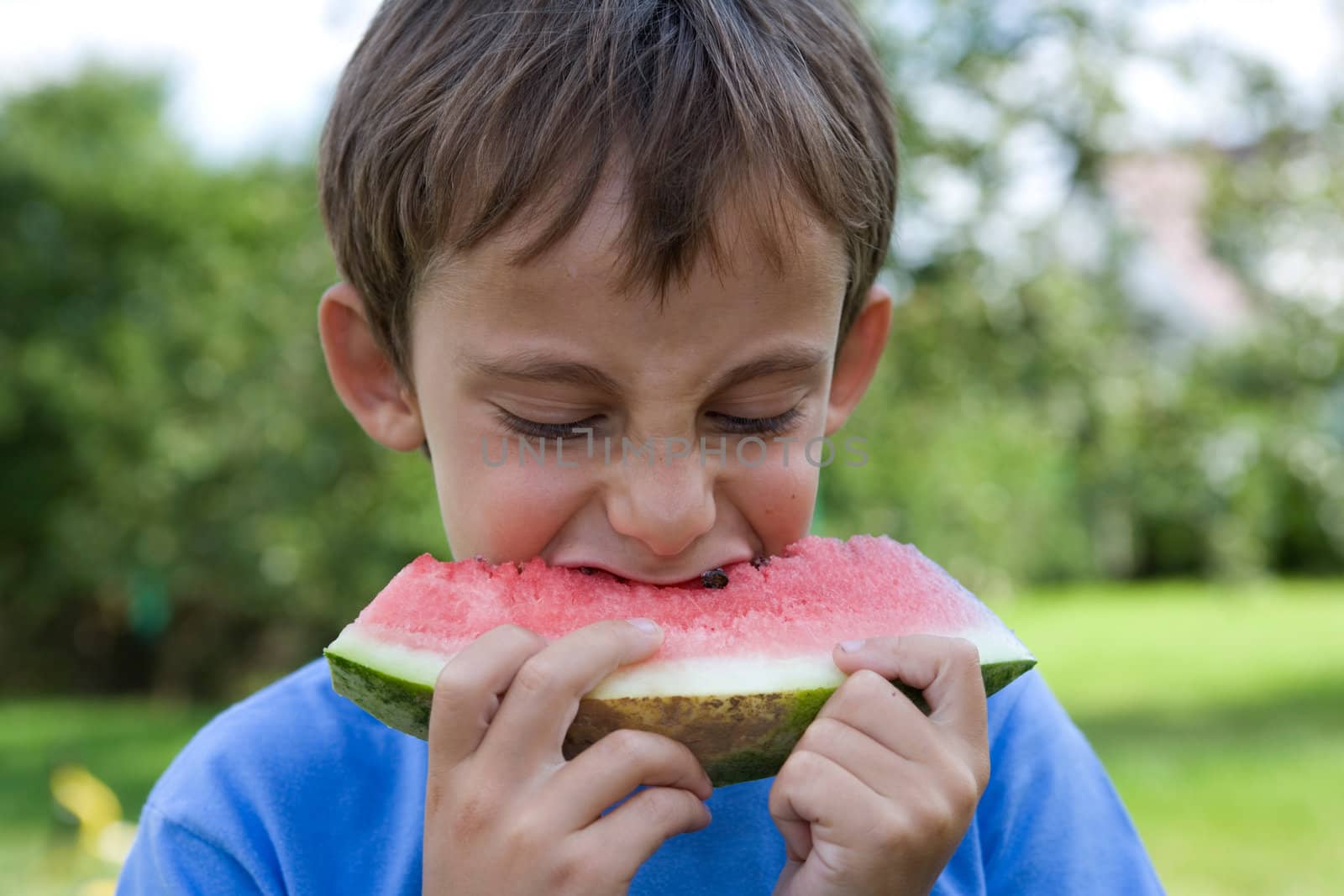 Boy eats watermelon