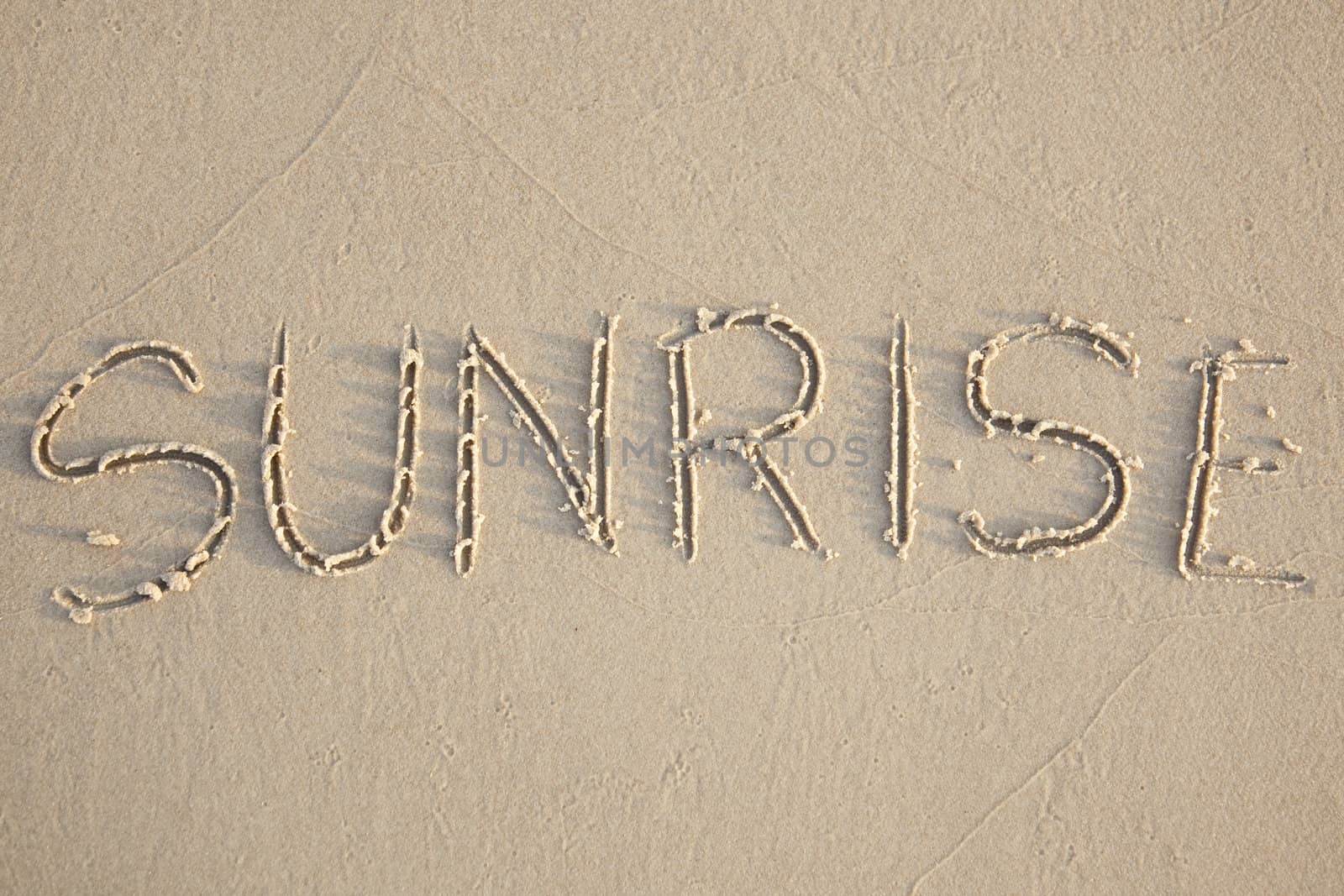 Sunrise written in the beach