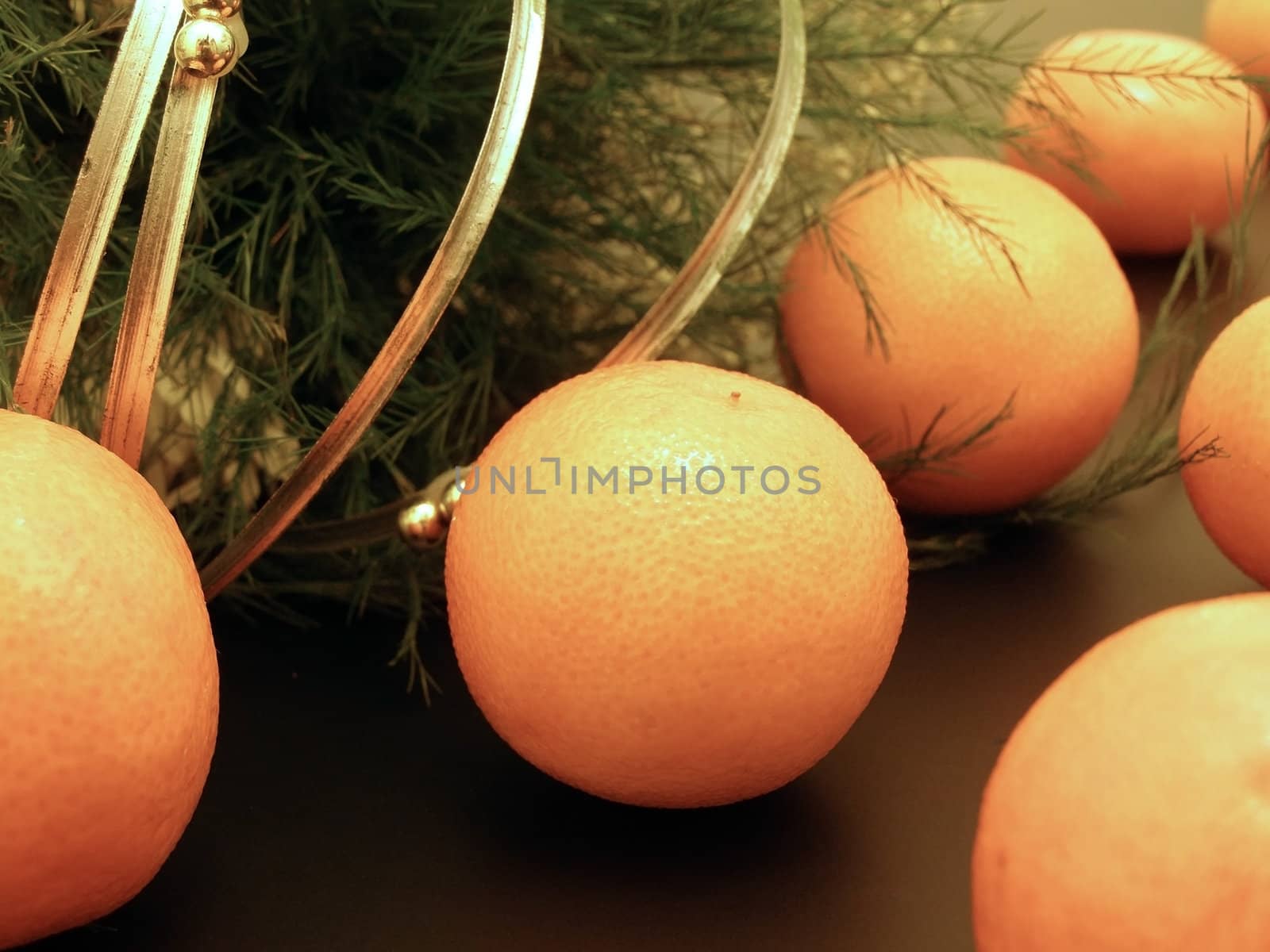 Row of oranges near green decoration     