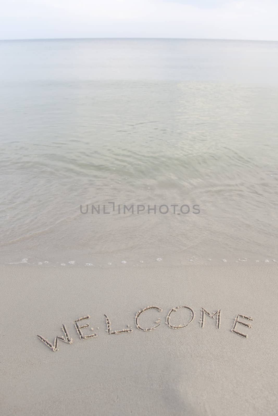 Welcome written in the beach