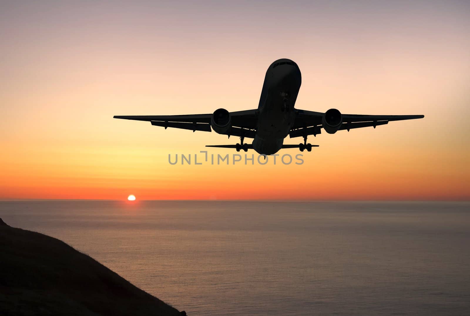 Large airliner approaching to land at sunrise