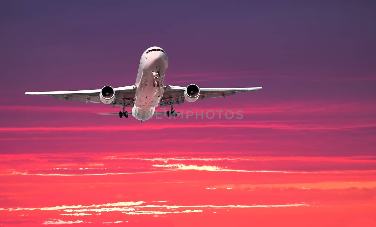 Widebody airliner on approach with colorful dramatic sky in the background