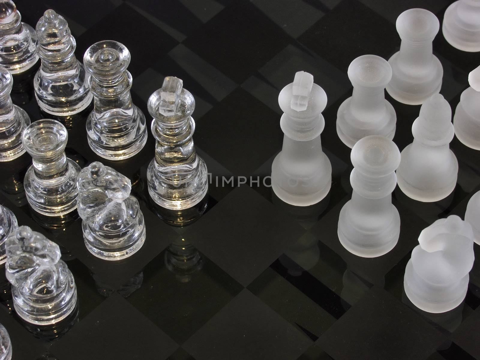 Frosted and clear chess pieces on a glass chessboard. Note the backgammon markings below the surface of the glass.