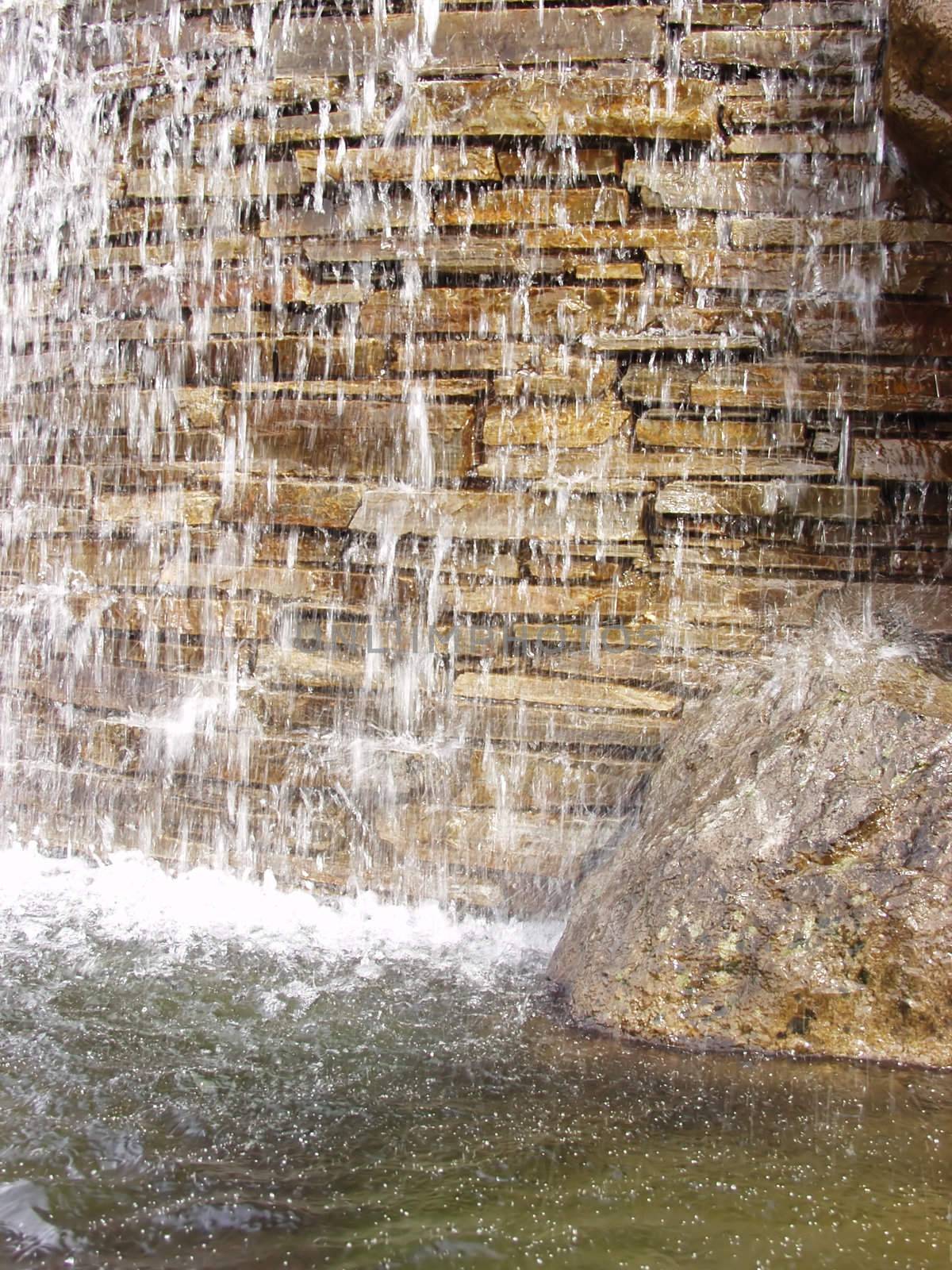 Background of a small waterfall over a stone wall.