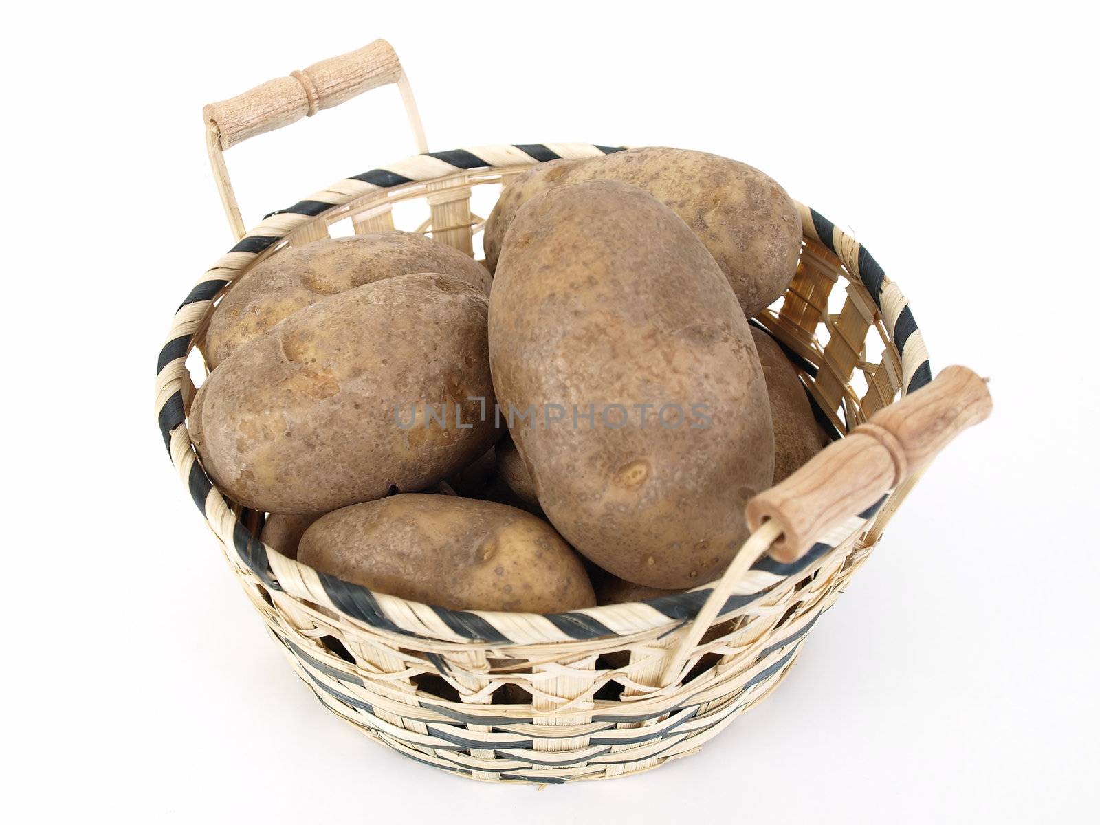 A wicker basket full of large baker potatoes. Over a white background