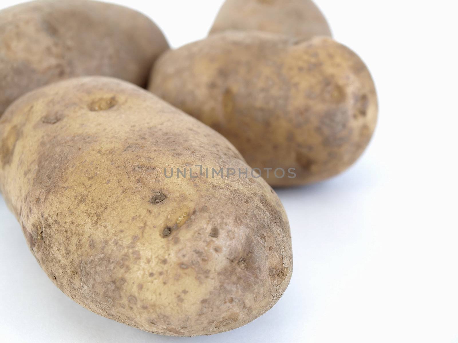 Large baker potatoes isolated on a white background.