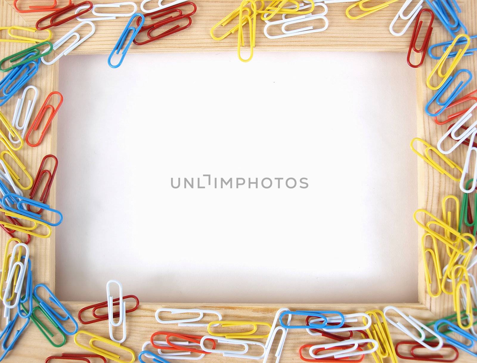 A tan wooden frame with colorful paperclips over a blank white background.