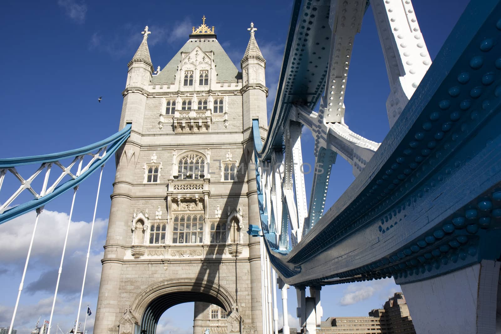 Close up detail of one of the blue supports and tower of Tower Bridge, London England