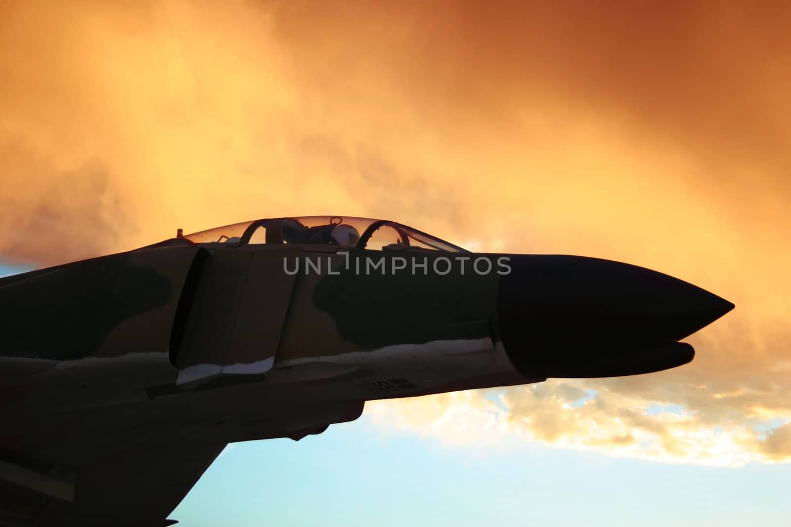 Vintage Vietnam era fighter plane flies off into the sunset