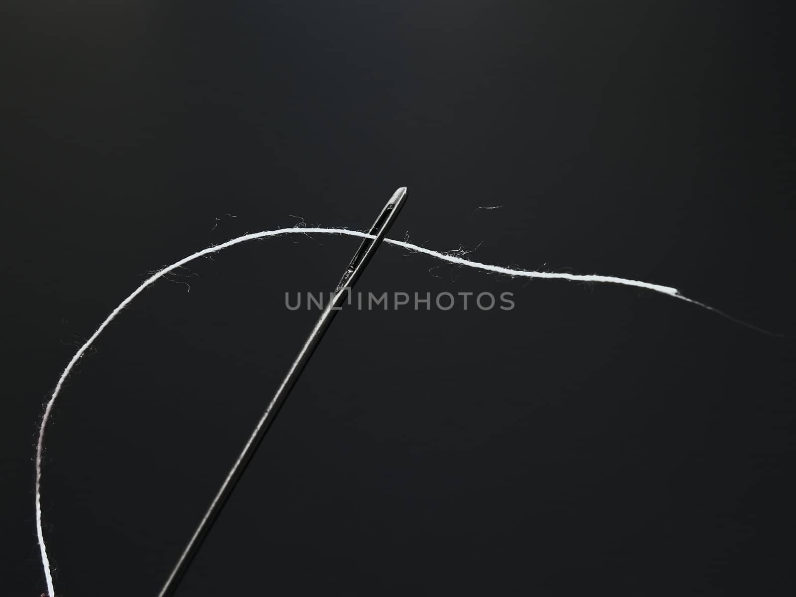 	
steel needle with the white thread through eyelet