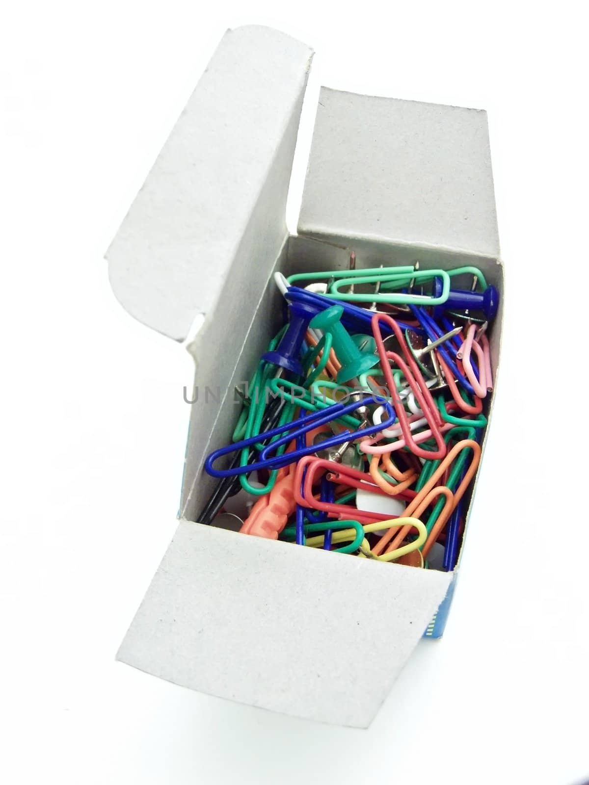 multicolored thumb tacks and pins in pack against white background