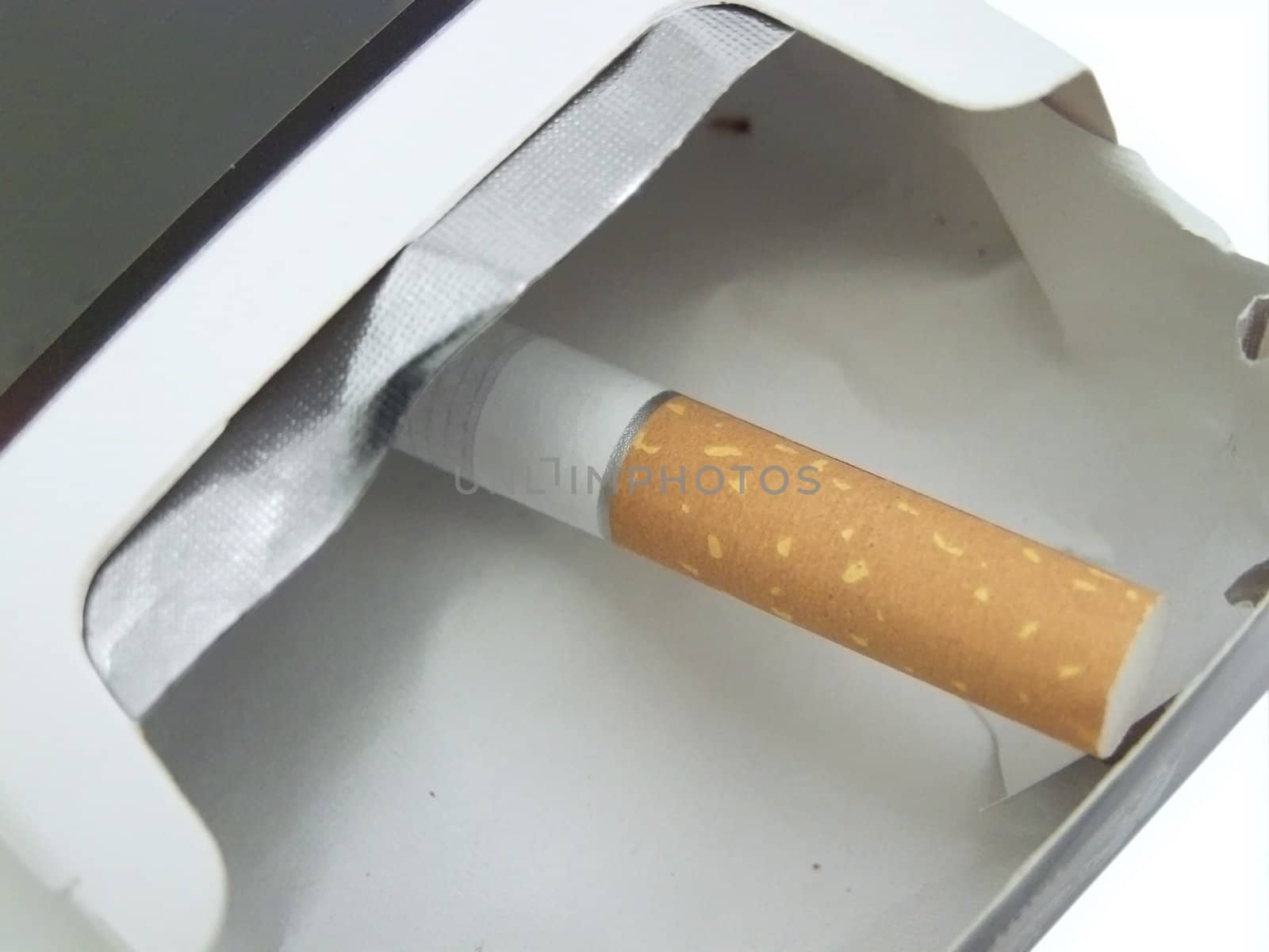 single cigarette in the empty cigarette box
