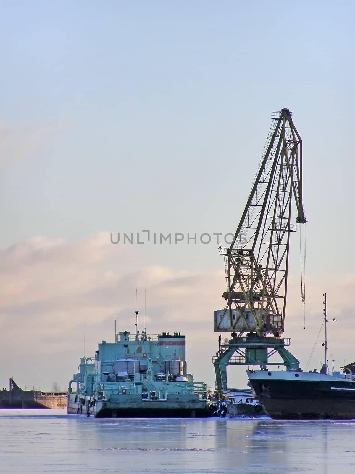 winter cargo side port with big ships and crane