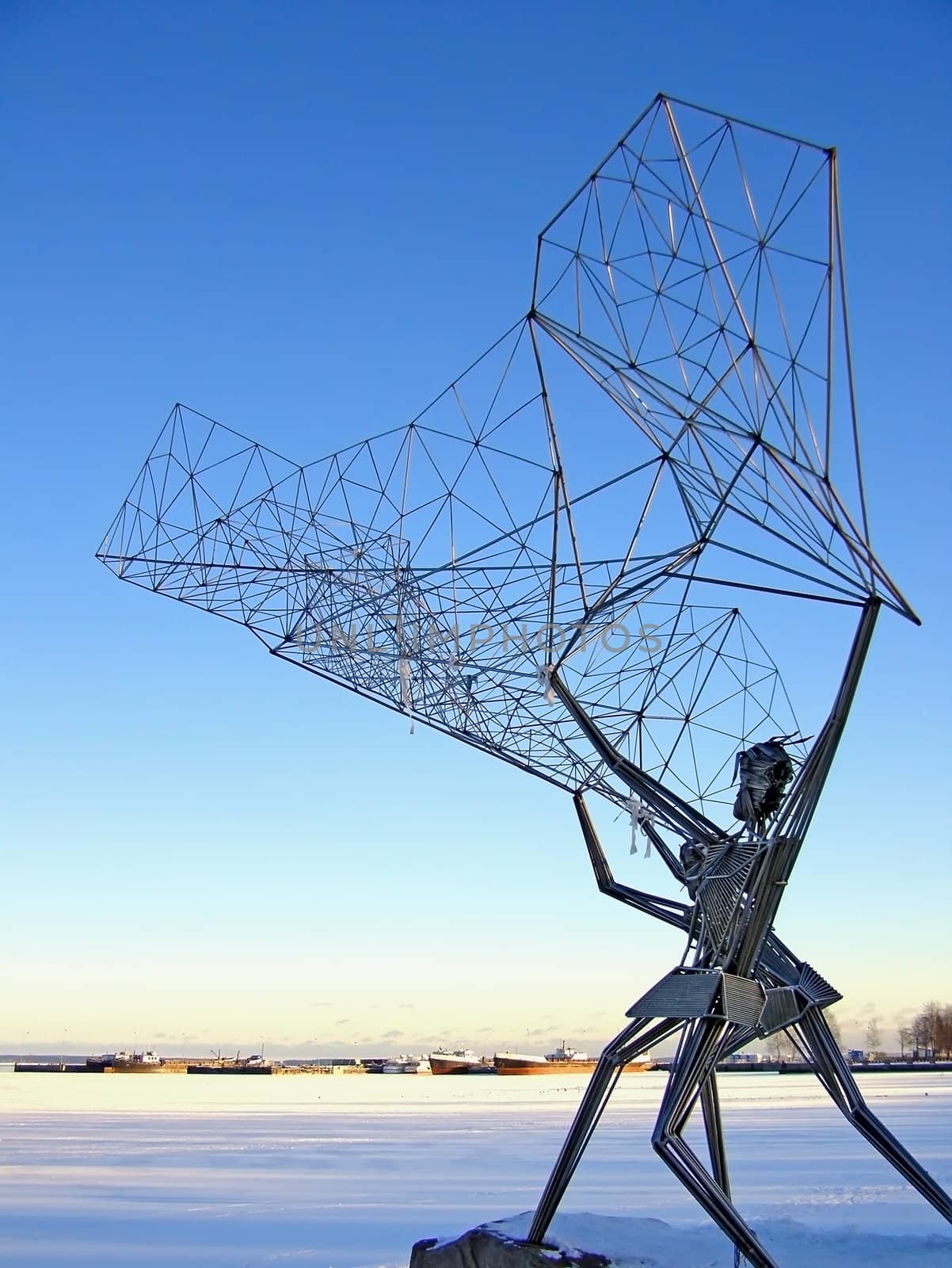 Winter metallic abstract sculpture with blue sky