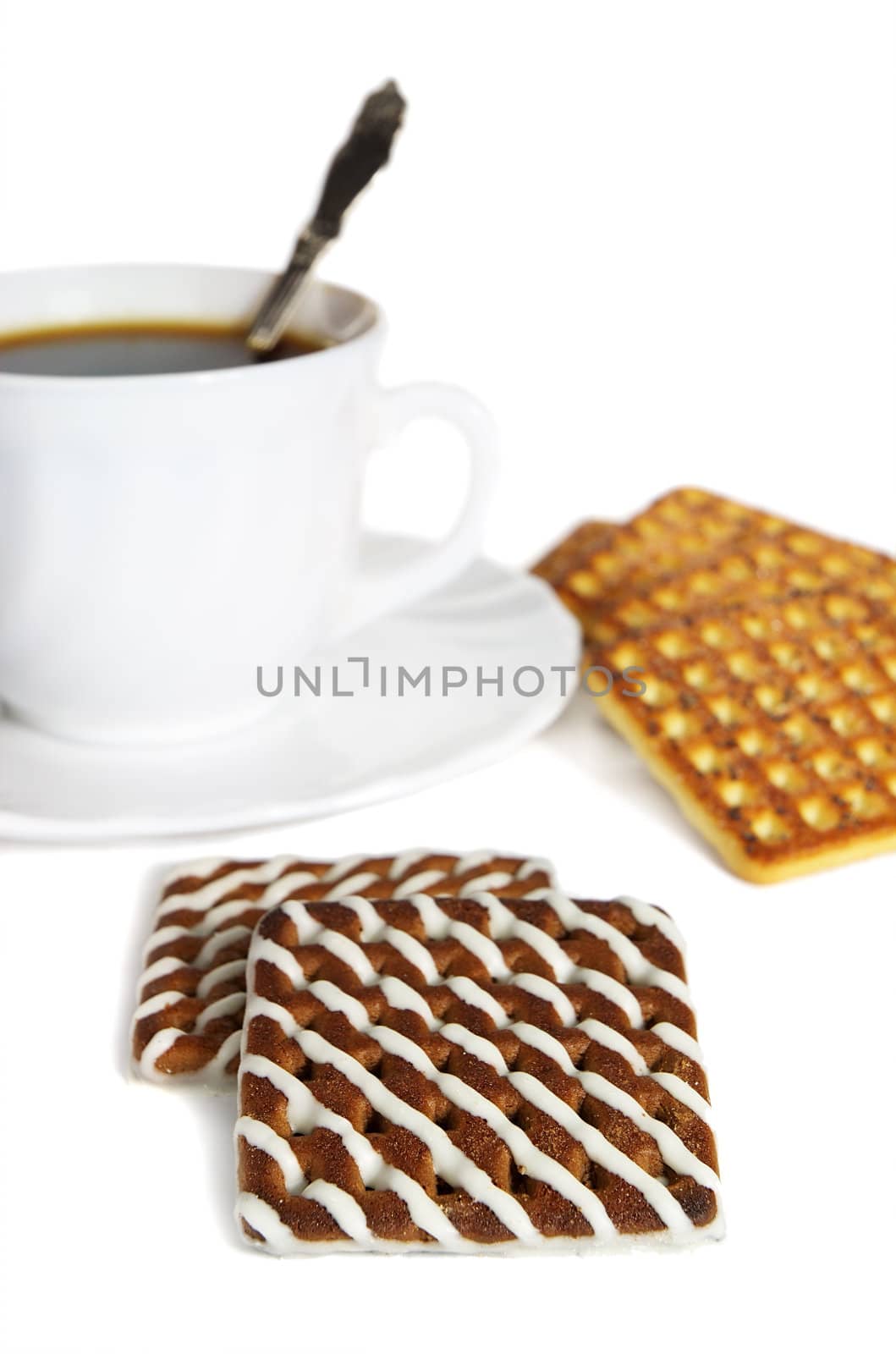 chocolate cookie with white cream and cup of tea on white background