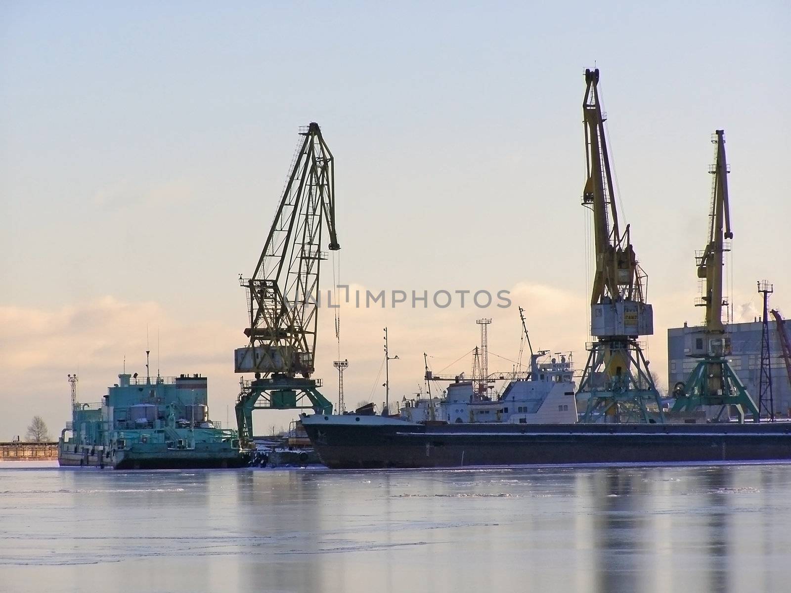 winter cargo side port with big ships and cranes