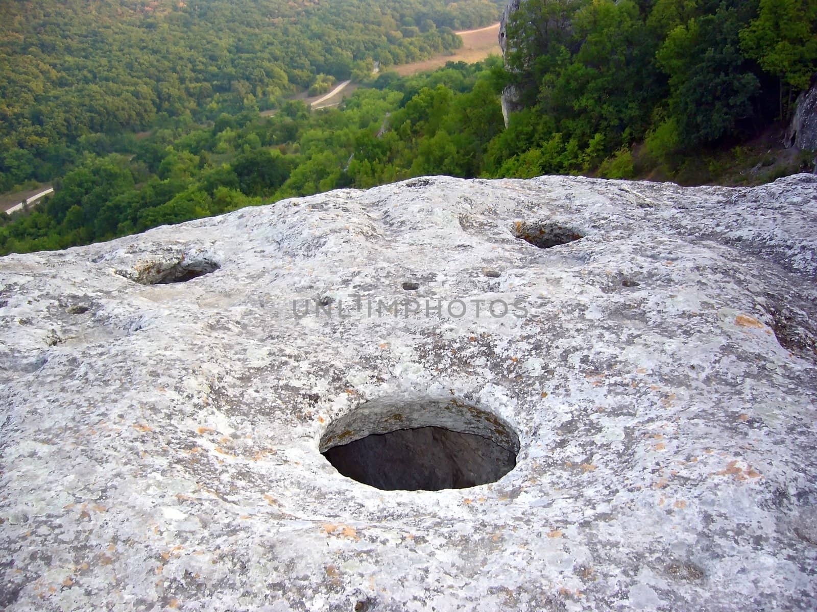 Big stone with three holes and nature