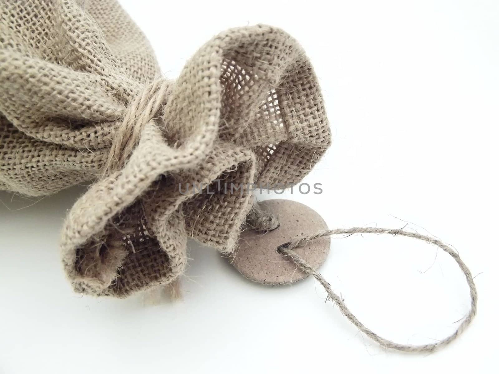 The part of the close beige linen sack with the tag label