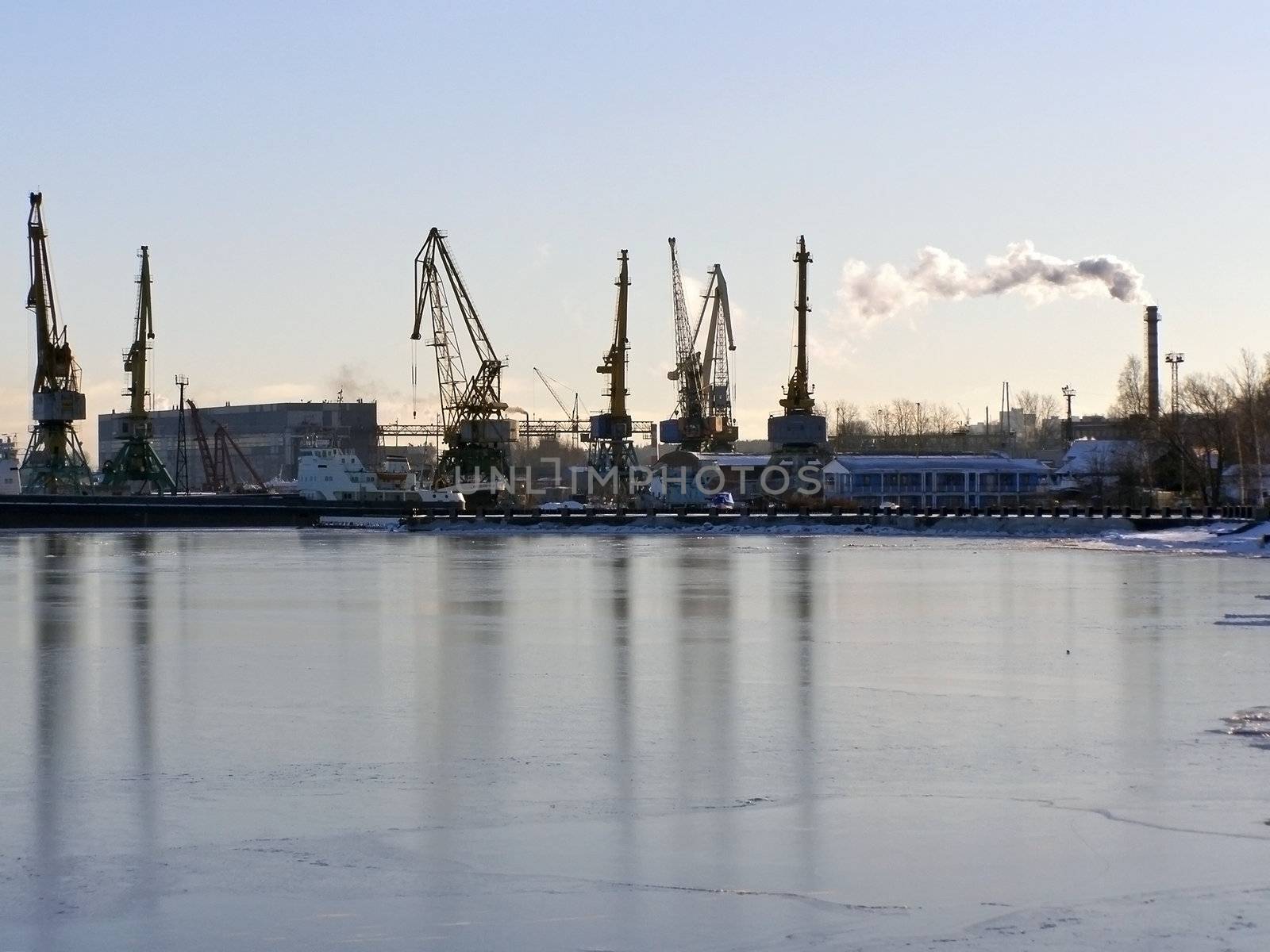 winter cargo side port with big ships and cranes