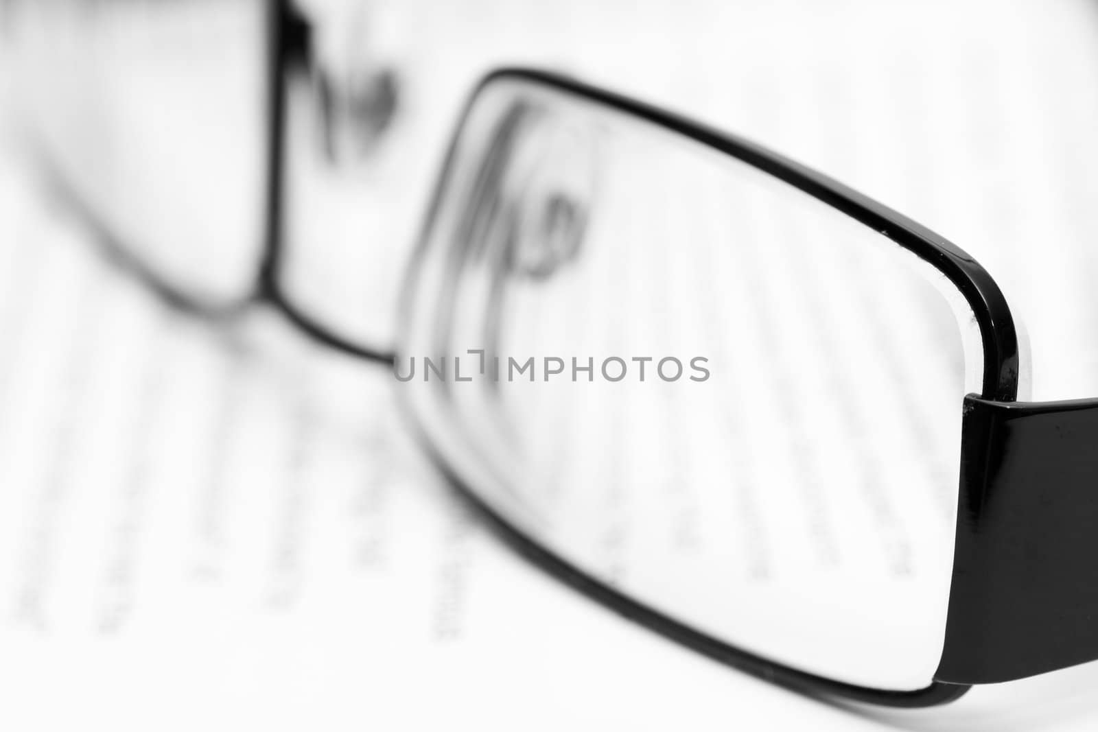 Eyeglasses on open book in black and white
