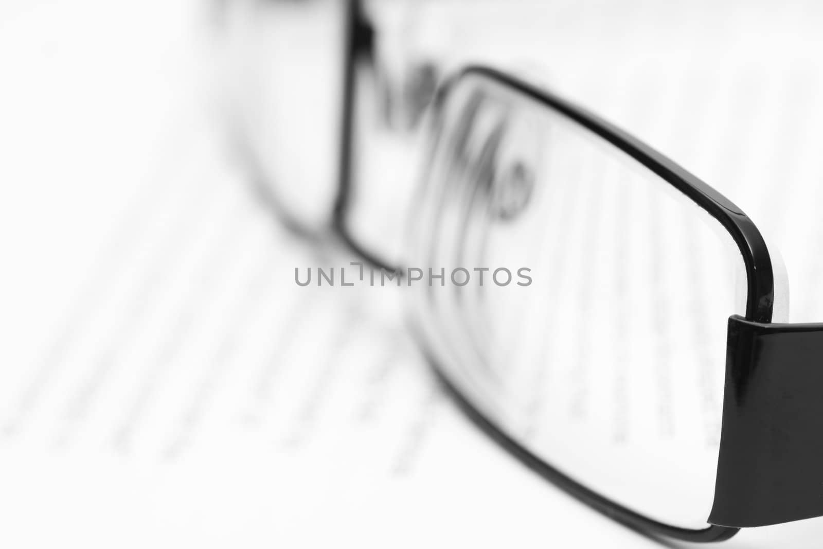 Eyeglasses on open book in black and white