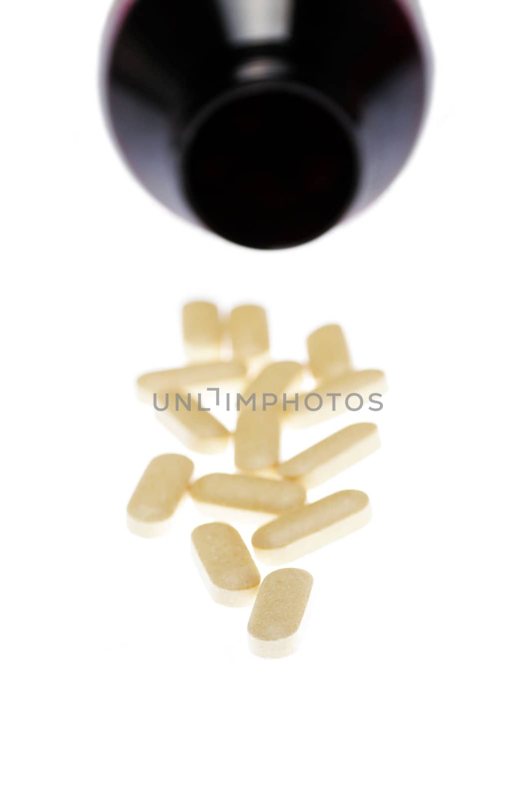Pills In Front Of Dark Bottle, Medical Background,  Focus On Front