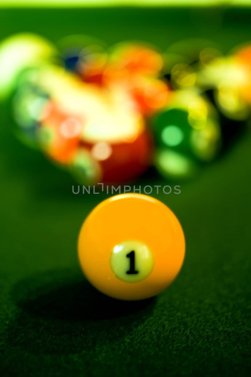 Close-up shot of a billiard balll on a green felt covered pool table