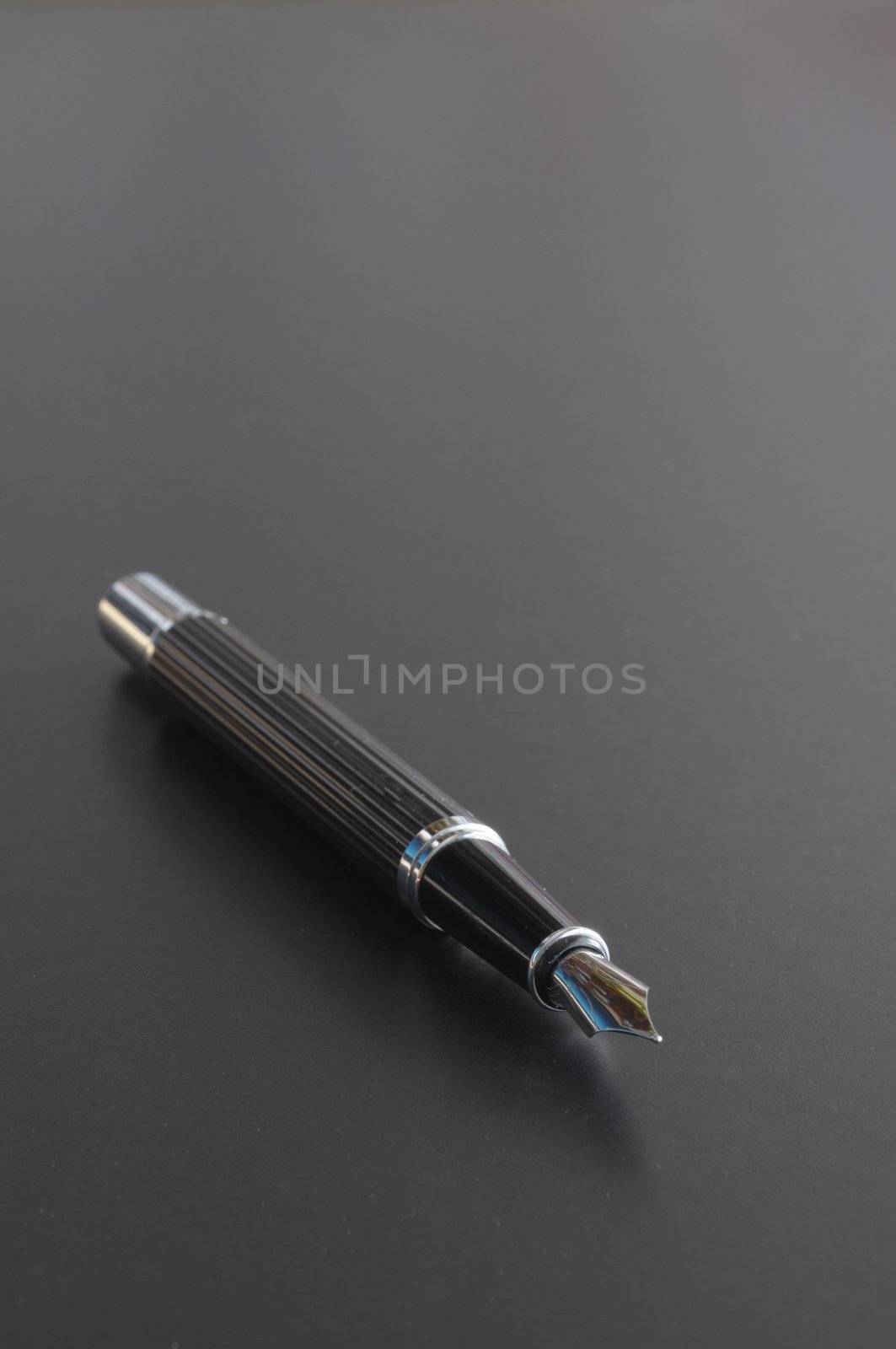 pen showing communication contact us or mail concept on black background