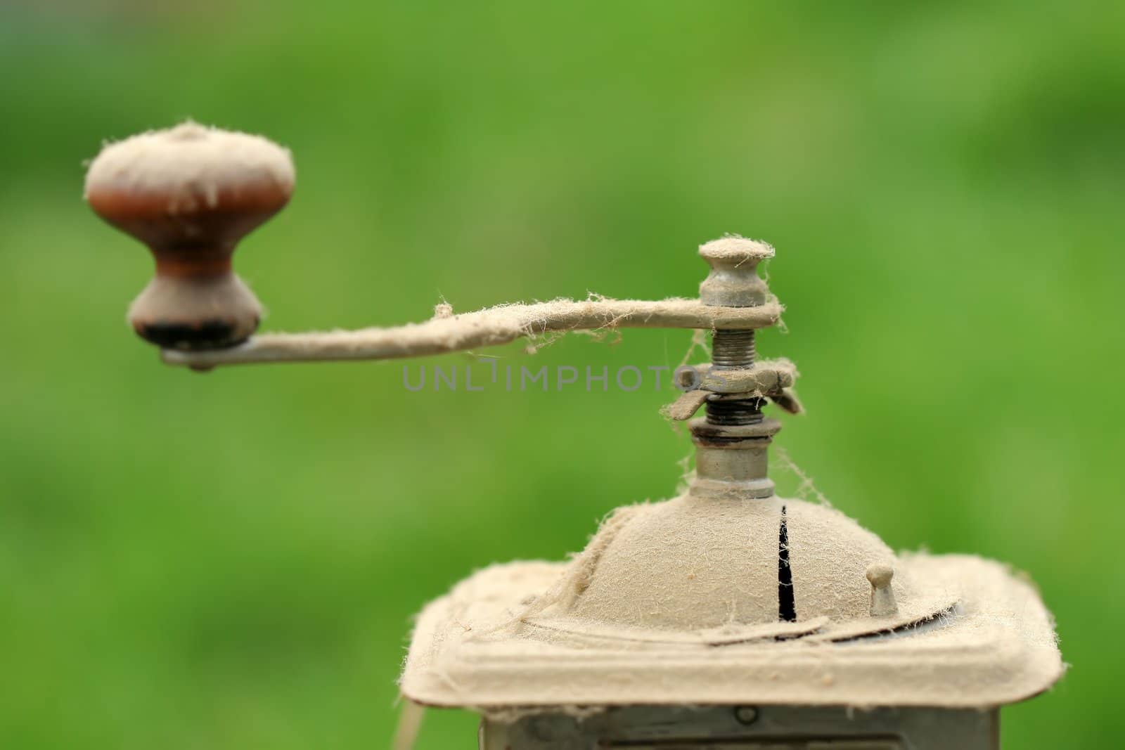 Old coffee grinder with dust 