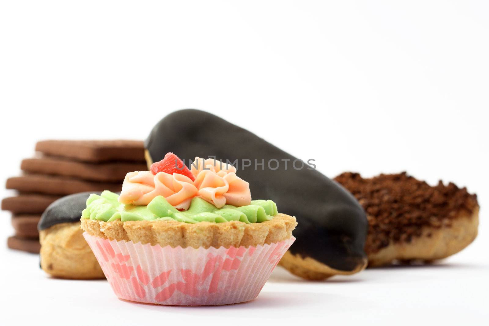 Various sponge cakes and cookies isolated on white background