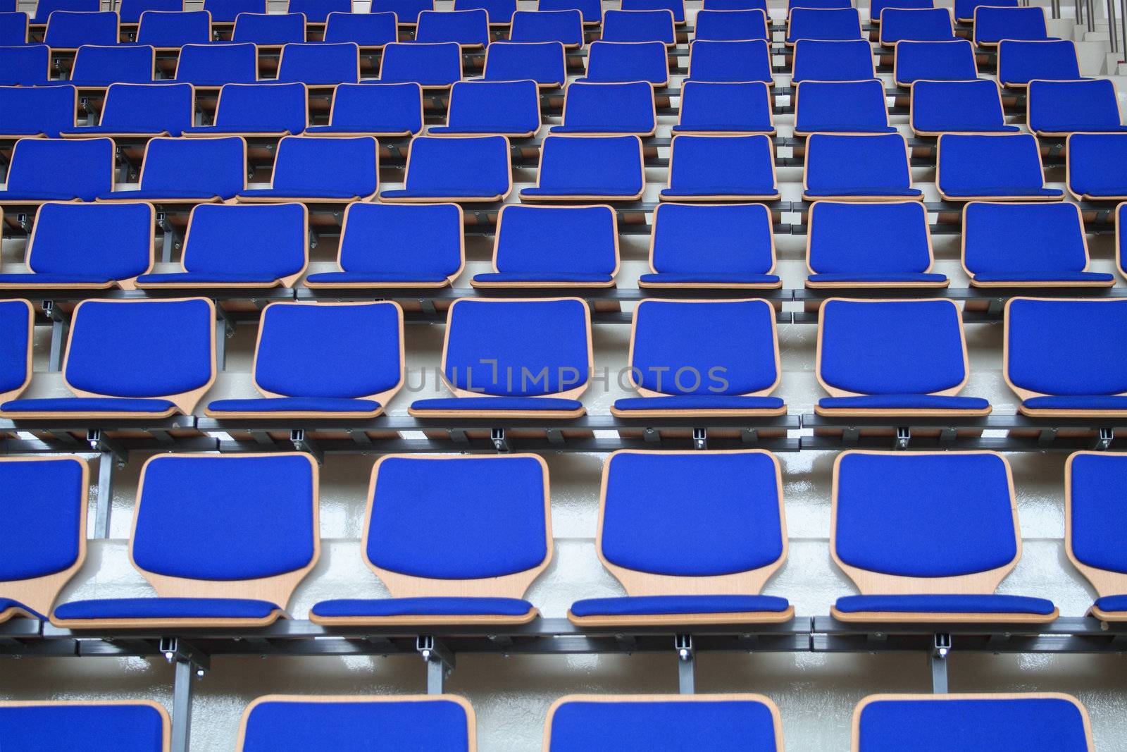 Rows of empty blue stadium seats background