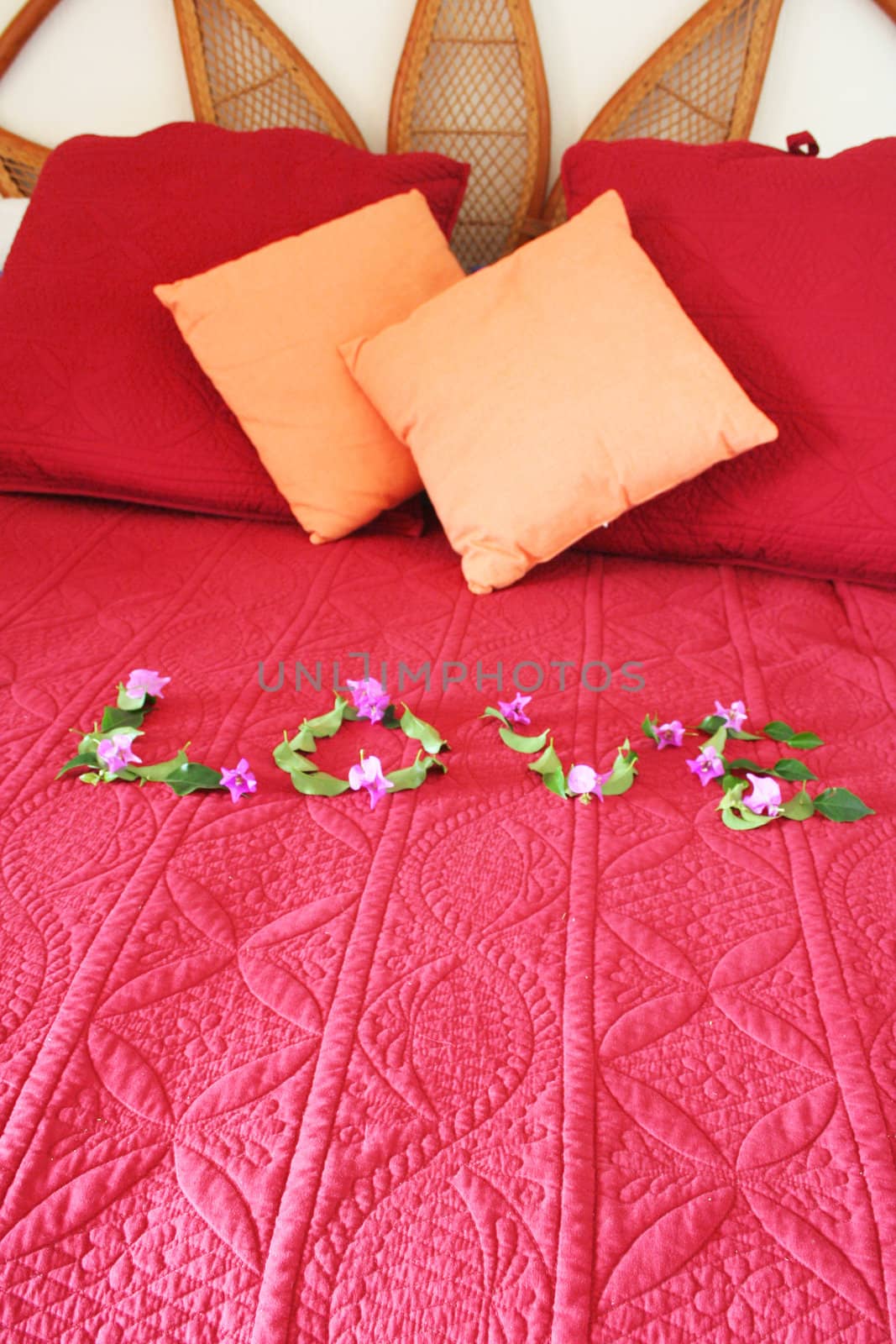 Bed with the word love spelled out with flowers